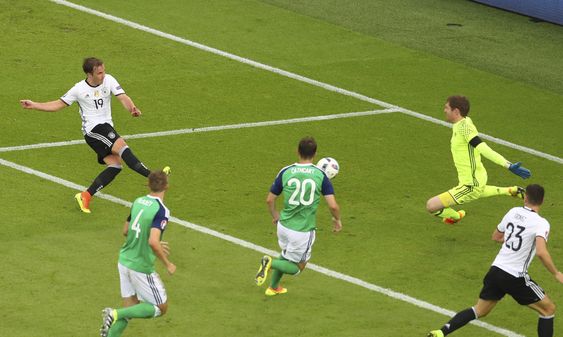 Michael McGovern right saves a shot by Germany's Mario Goetze left during the Euro 2016 Group C soccer match between Northern Ireland and Germany at the Parc des Princes stadium in Paris France Tuesday