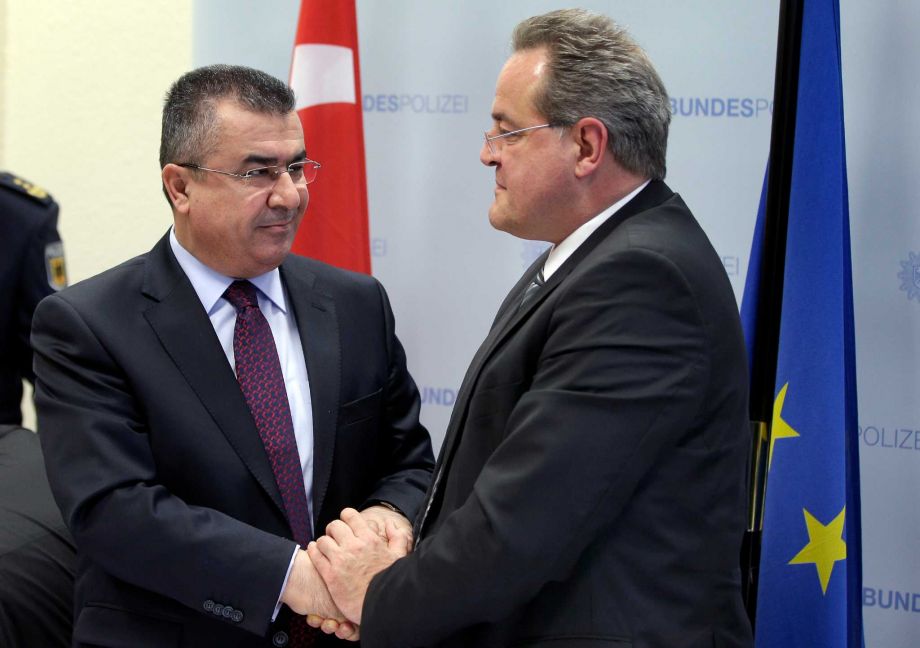 Turkish Governor Celalettin Lekesiz Manager of the General Security Administration left and Dieter Romann President of the Federal Police Headquarters right shake hands in Potsdam near Berlin Germany Wednesday Jan. 20 2016 after a press conferen