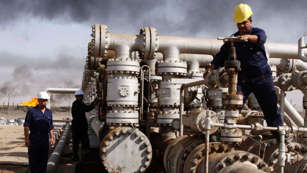 Iraqi laborers work at the Rumaila oil refinery in Zubair near Basra Iraq
